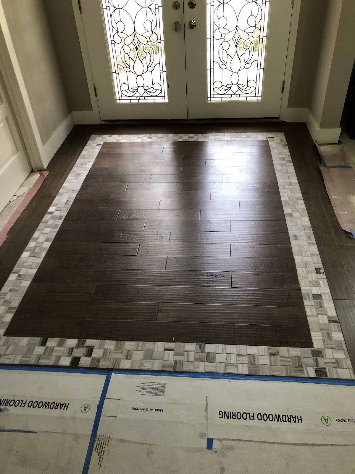 Custom hardwood and tile mosaic entryway floor