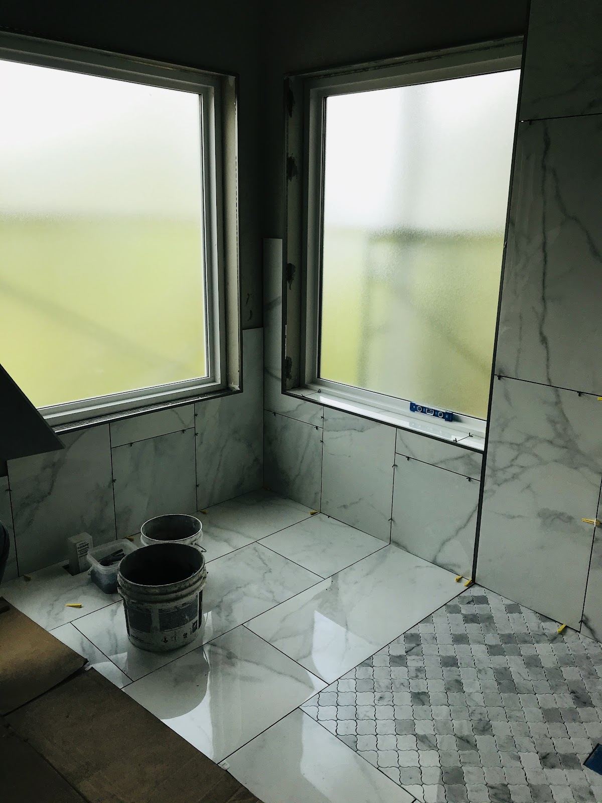 Large-format marble tile bathroom installation