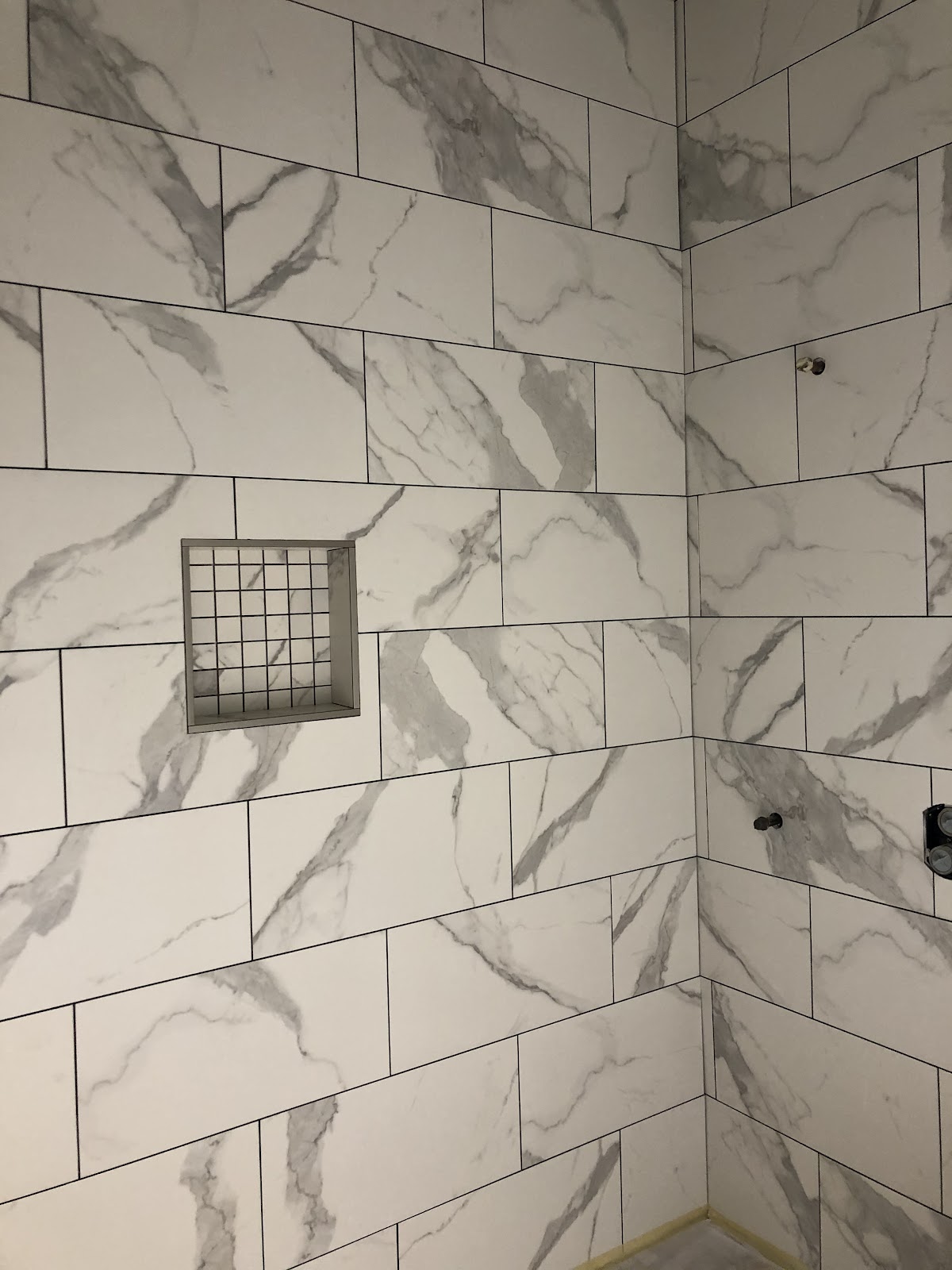 Marble-look porcelain shower tile installation